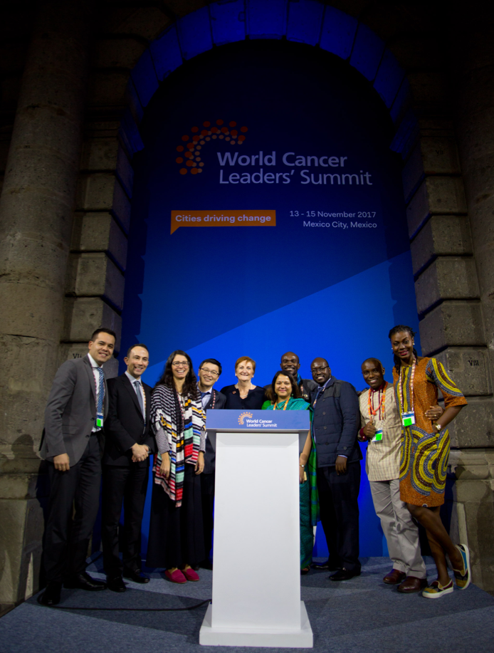 From left to right: Fabio Moraes (Previous YL), Youssef Zeidan, Roberta Marques, Dauren Adilbay, UICC President Prof. Sanchia Aranda, Supriya Sastri (green dress), Runcie Chidebe (Back – Previous YL), Paul Ebusu, Kelechi Eguzo, ‘Lola’James (Previous YL)